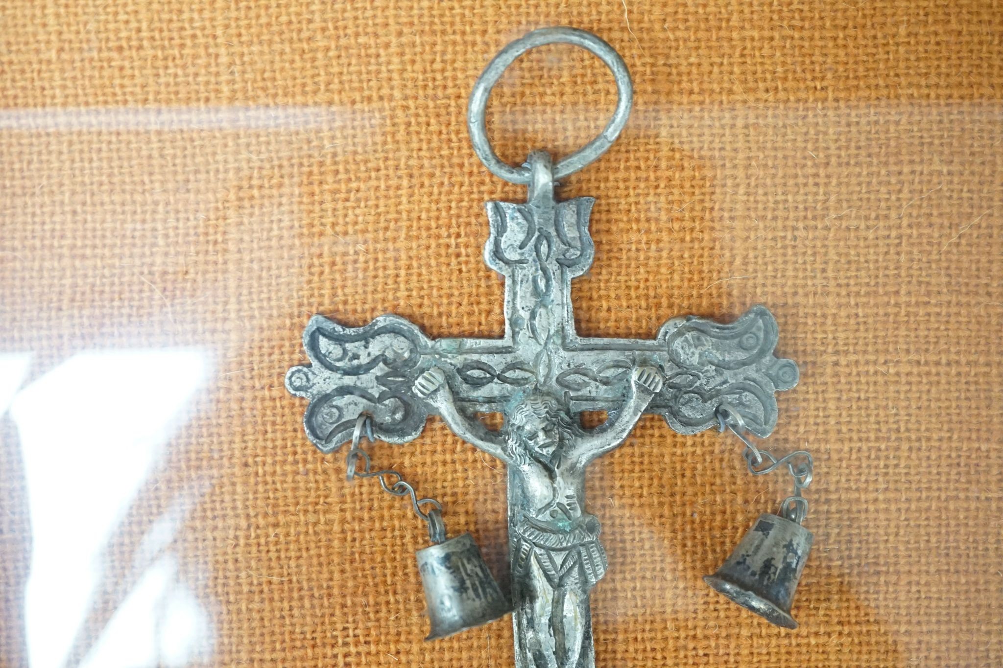 A carved crucifix and a framed metal Peruvian colonial crucifix, 50cm